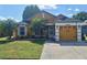 Charming single-story home with a manicured lawn, palm trees, and a two-car garage at 2979 Cool Breeze Cir, St Cloud, FL 34769