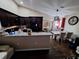 Well-lit kitchen and dining area with granite counters and stainless steel appliances at 2979 Cool Breeze Cir, St Cloud, FL 34769