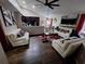 Bright living area with hardwood floors offering a modern design and comfortable seating at 2979 Cool Breeze Cir, St Cloud, FL 34769