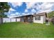 Spacious backyard with green grass, screen patio and a white privacy fence at 3103 Yorych Ln, Orlando, FL 32822