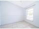 Inviting bedroom with neutral walls, tile floors, one window, and trim at 3103 Yorych Ln, Orlando, FL 32822