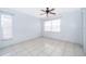 Inviting bedroom with neutral walls, tile floors, two windows, and ceiling fan at 3103 Yorych Ln, Orlando, FL 32822