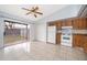 Bright kitchen featuring tile floors, classic appliances, and sliding door to an enclosed patio at 3103 Yorych Ln, Orlando, FL 32822