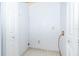Compact laundry room with tile floors and two separate closet spaces at 3103 Yorych Ln, Orlando, FL 32822