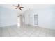 Bright, open living room featuring tile floors, ceiling fan, and neutral-colored walls at 3103 Yorych Ln, Orlando, FL 32822
