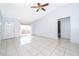 Bright, airy living room featuring tile flooring, ceiling fan, and a sliding glass door at 3103 Yorych Ln, Orlando, FL 32822