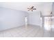 Spacious, light-filled living room featuring tile flooring and a ceiling fan fixture at 3103 Yorych Ln, Orlando, FL 32822