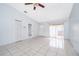 Bright, airy living room with tile flooring, ceiling fan and neutral paint at 3103 Yorych Ln, Orlando, FL 32822