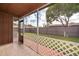 Screened patio featuring tile flooring, white lattice and a view of the fenced backyard at 3103 Yorych Ln, Orlando, FL 32822