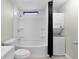 A bathroom and laundry combination featuring a shower and tub combination at 33506 Luana Ct, Leesburg, FL 34788