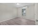 A well-lit bedroom with sleek laminate flooring and a modern mini-split AC unit at 33506 Luana Ct, Leesburg, FL 34788