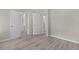 Bedroom with wood-look flooring and convenient access to the bathroom and hallway at 33506 Luana Ct, Leesburg, FL 34788