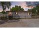 Charming single-story home featuring well-maintained yard, fenced perimeter, and inviting front entrance with wood stairs at 33506 Luana Ct, Leesburg, FL 34788