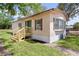 This single Gathering home has a wooden deck and is surrounded by grass at 33506 Luana Ct, Leesburg, FL 34788