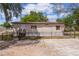 Charming single-story home featuring well-maintained yard, fenced perimeter, and inviting front entrance with wood stairs at 33506 Luana Ct, Leesburg, FL 34788