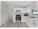Modern kitchen with stainless steel appliances and white cabinets, ample counter space, and recessed lighting at 33506 Luana Ct, Leesburg, FL 34788