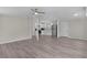 Spacious living area with wood-look flooring, flowing seamlessly into a kitchen with stainless steel appliances at 33506 Luana Ct, Leesburg, FL 34788