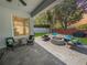 Inviting outdoor patio with comfortable seating, a fire pit, and a well-manicured lawn at 3420 Gerber Daisy Ln, Oviedo, FL 32766