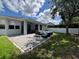 Outdoor patio with a fire pit, stylish furniture, and a view of the home's exterior at 3420 Gerber Daisy Ln, Oviedo, FL 32766