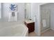 This bathroom features a soaking tub, walk-in shower and bright natural light at 3420 Gerber Daisy Ln, Oviedo, FL 32766