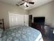 Comfortable bedroom featuring a ceiling fan, closet, and spacious dresser at 3420 Gerber Daisy Ln, Oviedo, FL 32766