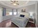 This bedroom features wood floors, a ceiling fan, a large window, and soft, natural light at 3420 Gerber Daisy Ln, Oviedo, FL 32766