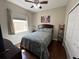 Cozy bedroom with a ceiling fan, closet, and sunlit window at 3420 Gerber Daisy Ln, Oviedo, FL 32766