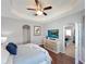 This main bedroom features a tray ceiling, wood floors, a ceiling fan and lots of natural light at 3420 Gerber Daisy Ln, Oviedo, FL 32766