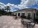 Clubhouse exterior showing outdoor patio area with tables and chairs, and stone accents at 3420 Gerber Daisy Ln, Oviedo, FL 32766