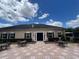 Well-maintained community building with a patio, seating, and landscaped grounds offering a welcoming and functional space at 3420 Gerber Daisy Ln, Oviedo, FL 32766