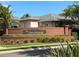 Attractive community sign for 'The Sanctuary' set among manicured landscaping at 3420 Gerber Daisy Ln, Oviedo, FL 32766