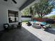 Outdoor patio featuring comfortable seating, a fire pit, and a view of the landscaped backyard at 3420 Gerber Daisy Ln, Oviedo, FL 32766