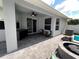 Covered patio featuring a ceiling fan, ample seating, and a view of the landscaped backyard at 3420 Gerber Daisy Ln, Oviedo, FL 32766