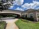 Exterior shot showcasing a covered entrance, beautiful landscaping, and manicured hedges at 3420 Gerber Daisy Ln, Oviedo, FL 32766