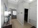Bright entryway with tile flooring, and an adjacent laundry room and living room at 3420 Gerber Daisy Ln, Oviedo, FL 32766