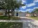 Charming single-Gathering home boasts a well-manicured lawn and inviting curb appeal at 3420 Gerber Daisy Ln, Oviedo, FL 32766