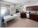 Open-concept kitchen featuring stainless steel appliances, tile flooring and a lovely view of the living room at 3420 Gerber Daisy Ln, Oviedo, FL 32766