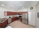 Bright kitchen with stainless steel appliances, ample counter space, and tiled flooring at 3420 Gerber Daisy Ln, Oviedo, FL 32766