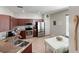Well-equipped kitchen features stainless steel appliances and warm wood cabinets at 3420 Gerber Daisy Ln, Oviedo, FL 32766