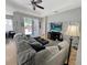 Bright living area with a comfortable sectional sofa and views of the outdoor patio at 3420 Gerber Daisy Ln, Oviedo, FL 32766