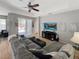 Spacious living room featuring a ceiling fan and sliding glass doors leading to the patio at 3420 Gerber Daisy Ln, Oviedo, FL 32766