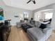 Spacious living room boasting a sectional sofa, hardwood floors, and views into the dining area at 3420 Gerber Daisy Ln, Oviedo, FL 32766