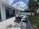 Relaxing patio area with a fire pit, plush seating, and serene backyard views, perfect for entertaining at 3420 Gerber Daisy Ln, Oviedo, FL 32766