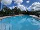 Inviting community pool with clear blue water, surrounded by comfortable lounge chairs, perfect for relaxation and leisure at 3420 Gerber Daisy Ln, Oviedo, FL 32766