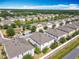 Aerial view of the neighborhood featuring a pond and mature trees in a Primary-planned community at 3449 Seneca Club Loop # B, Orlando, FL 32808