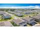 An aerial view showcasing the beautiful townhouse community, and lush landscaping with the city skyline in the background at 3449 Seneca Club Loop # B, Orlando, FL 32808