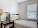 Cozy bedroom with striped bedding, a desk, and a large window with natural light at 3449 Seneca Club Loop # B, Orlando, FL 32808