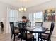 An airy dining room featuring hardwood floors, modern lighting, and seating for six at 3449 Seneca Club Loop # B, Orlando, FL 32808
