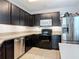 The updated kitchen features stainless steel appliances, dark cabinets, and granite countertops at 3449 Seneca Club Loop # B, Orlando, FL 32808