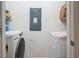 Bright laundry room with washer, dryer, and convenient shelving for storage at 3449 Seneca Club Loop # B, Orlando, FL 32808